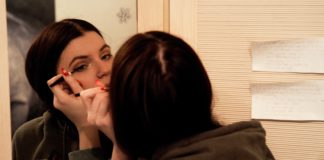 Putting on eyeliner